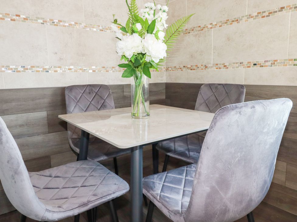 A dining room with a table and chairs at Two Bed Apartment No.4 Newquay