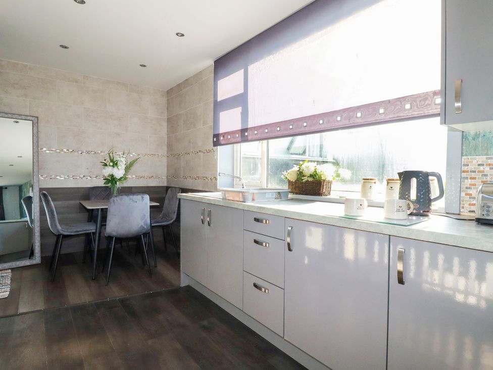 A kitchen with a table and chairs at Two Bed Apartment No.4 Newquay