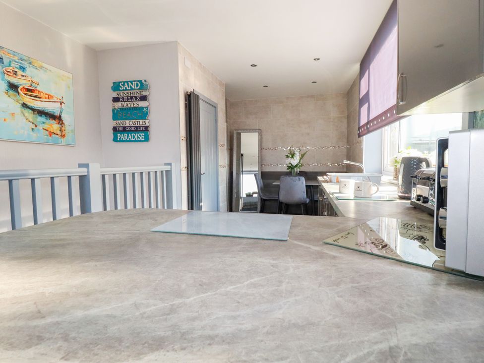 A kitchen with a table and chairs at Two Bed Apartment No.4 Newquay