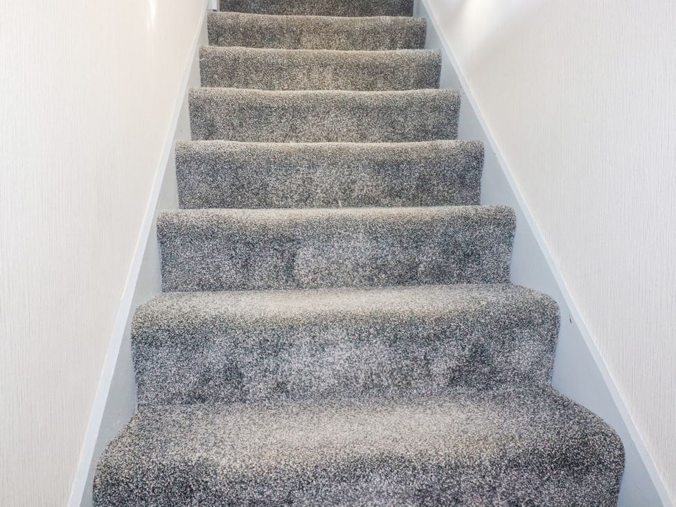 A staircase with carpet steps at Two Bed Apartment No.4 Newquay