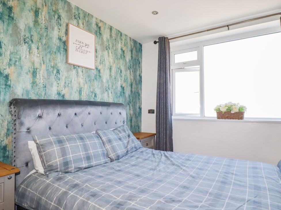 A bedroom with a bed and window at Two Bed Apartment No.4 Newquay