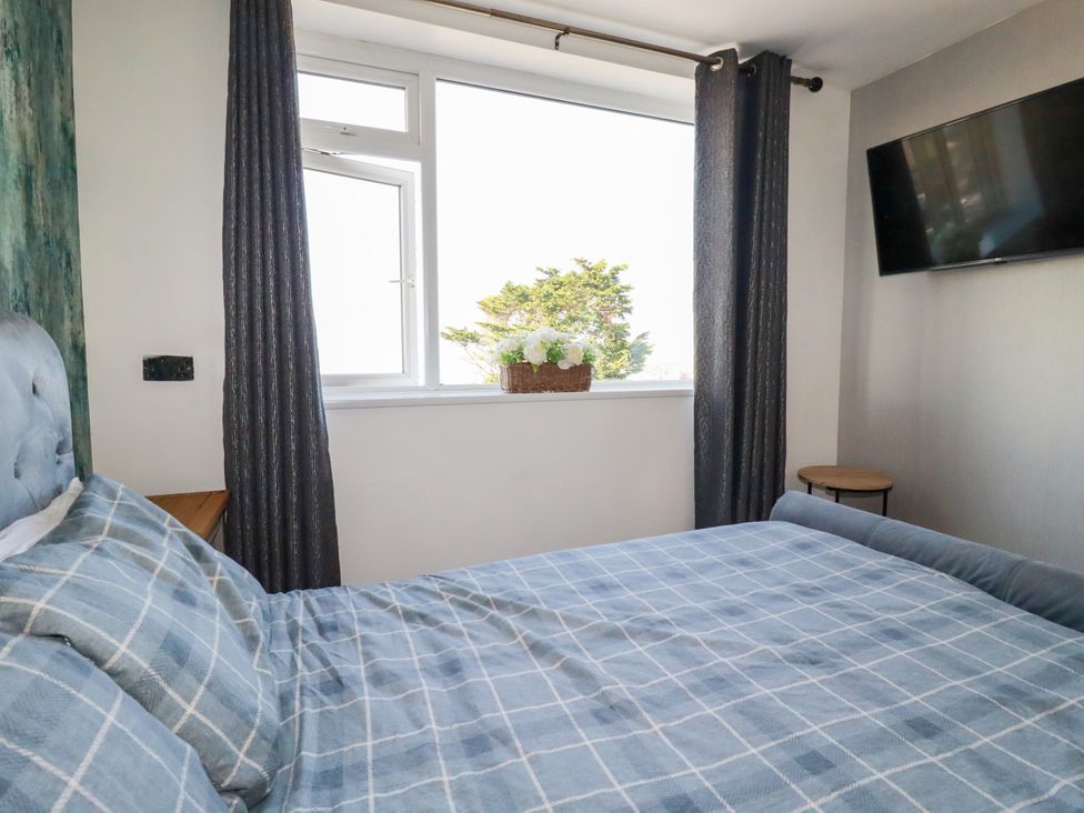 A bedroom with a bed and a window at Two Bed Apartment No.4 Newquay