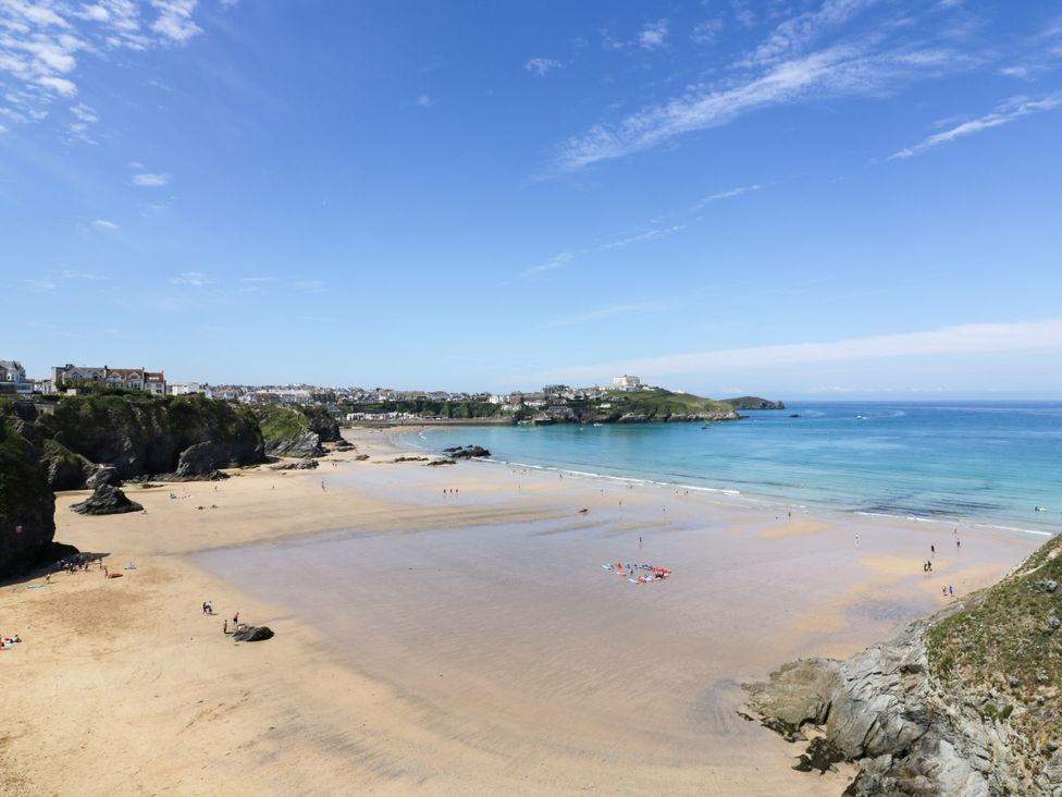 A beach with people and cliffs at Two Bed Apartment No.4 Newquay