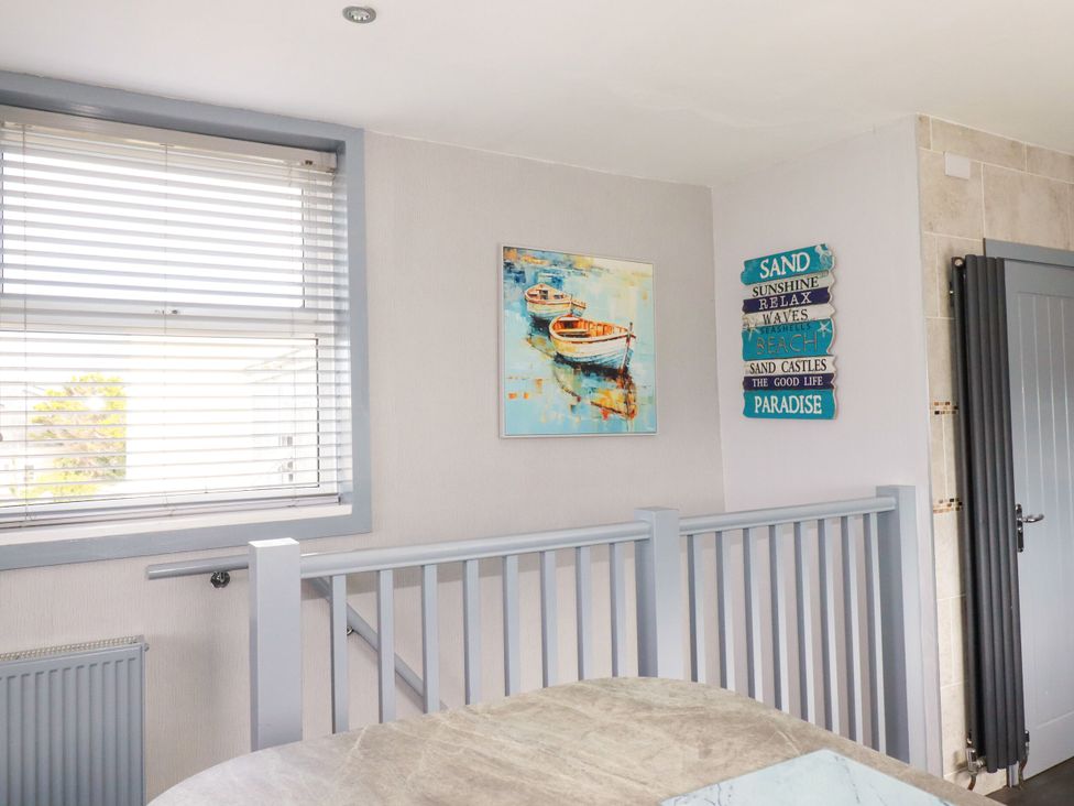 A room with a painting and decorative signs at Penthouse No.3 Newquay