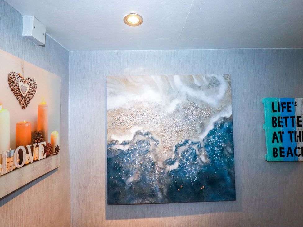 A room with wall art and a decorative sign at Penthouse No.3 in Newquay
