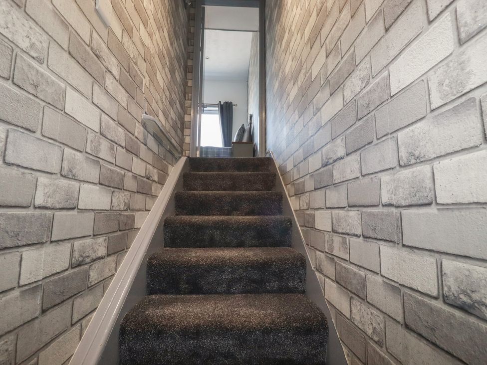 Staircase leading to a doorway at Penthouse No.3 in Newquay