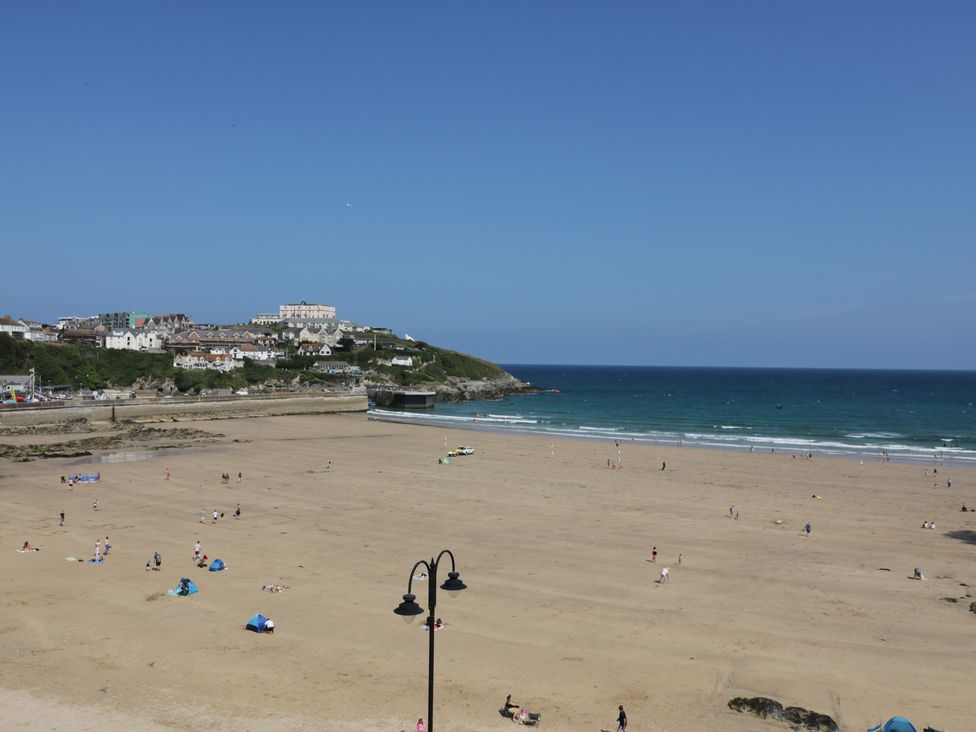 A beach with people and buildings at Penthouse No.3 in Newquay