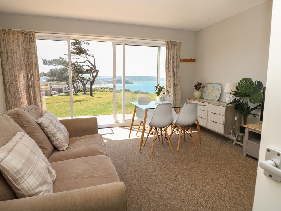 A living room with a sofa and table at 57 Cliff End in Freshwater