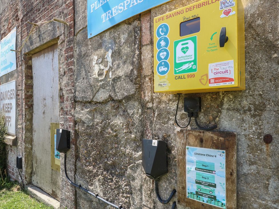 A defibrillator and signage at 57 Cliff End Freshwater