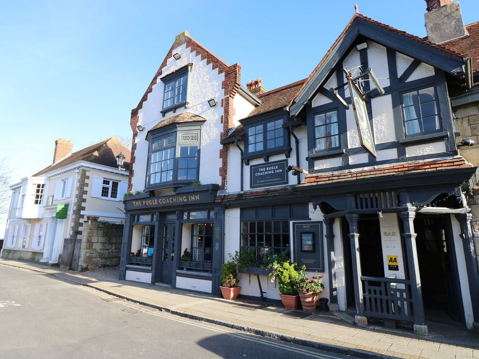 A building exterior with signage at The Pugle Coaching Inn in Freshwater