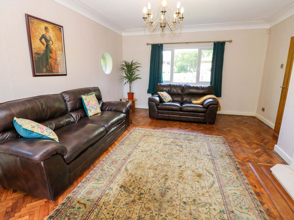 A living room with two sofas and a chandelier at 331 Coniscliffe Road in Darlington