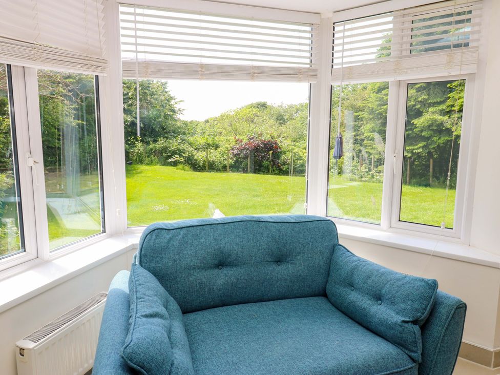 A conservatory with a couch and garden view at 331 Coniscliffe Road in Darlington