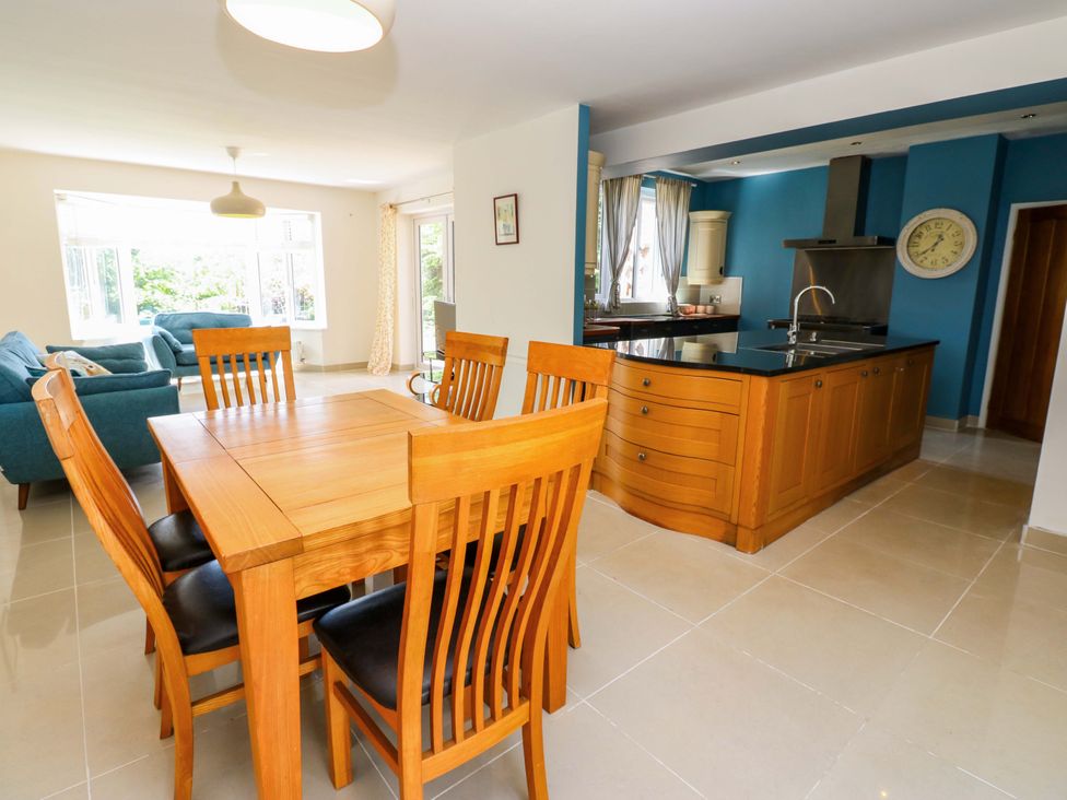 A dining room with a table and chairs and an open kitchen at 331 Coniscliffe Road in Darlington