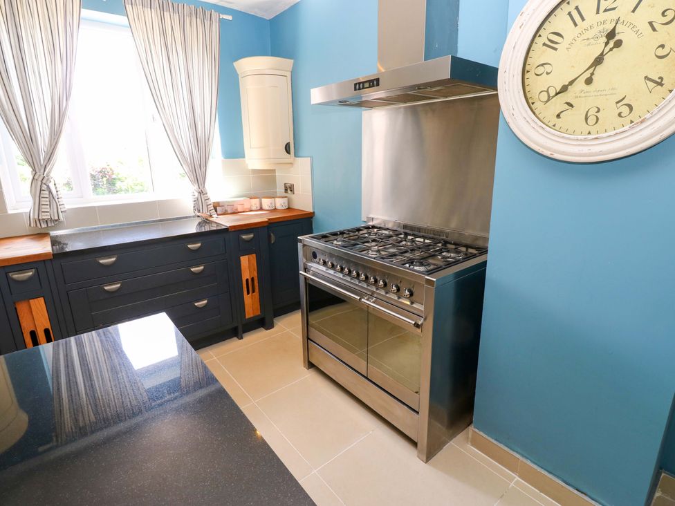 A kitchen with cabinets, stove, and window at 331 Coniscliffe Road, Darlington