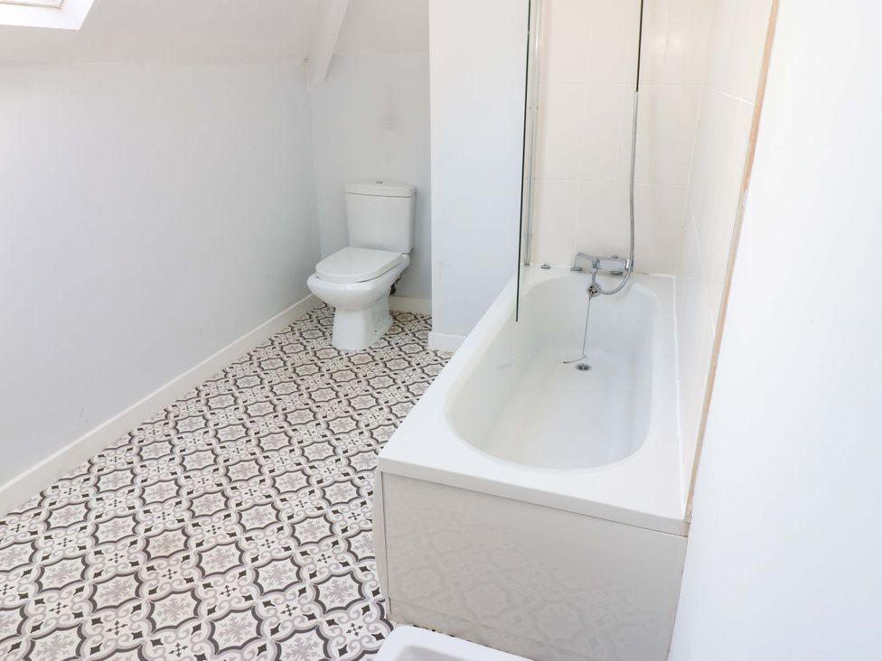 A bathroom with a toilet and bathtub at 331 Coniscliffe Road in Darlington