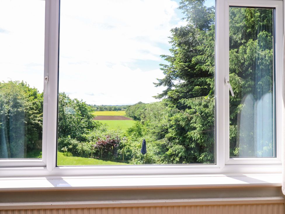 A view from a window overlooking trees and a field at 331 Coniscliffe Road in Darlington