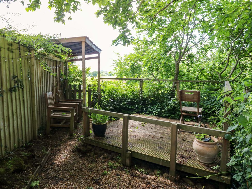 A garden area with wooden chairs and a planter at 331 Coniscliffe Road in Darlington