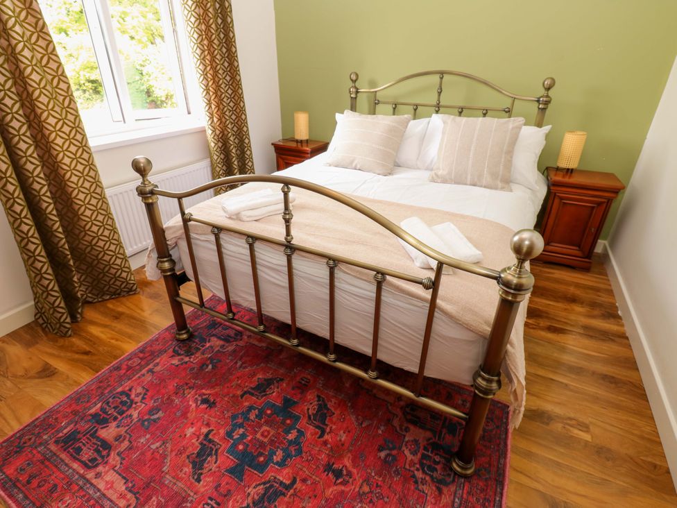 A bedroom with a bed and nightstands at 331 Coniscliffe Road, Darlington