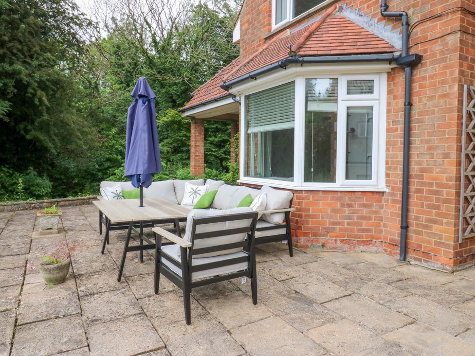 A patio area with seating and an umbrella at 331 Coniscliffe Road in Darlington