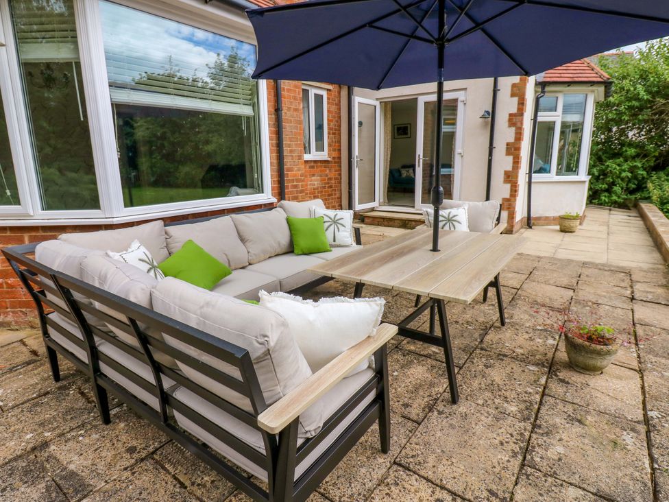 A patio with an outdoor sofa and table at 331 Coniscliffe Road in Darlington
