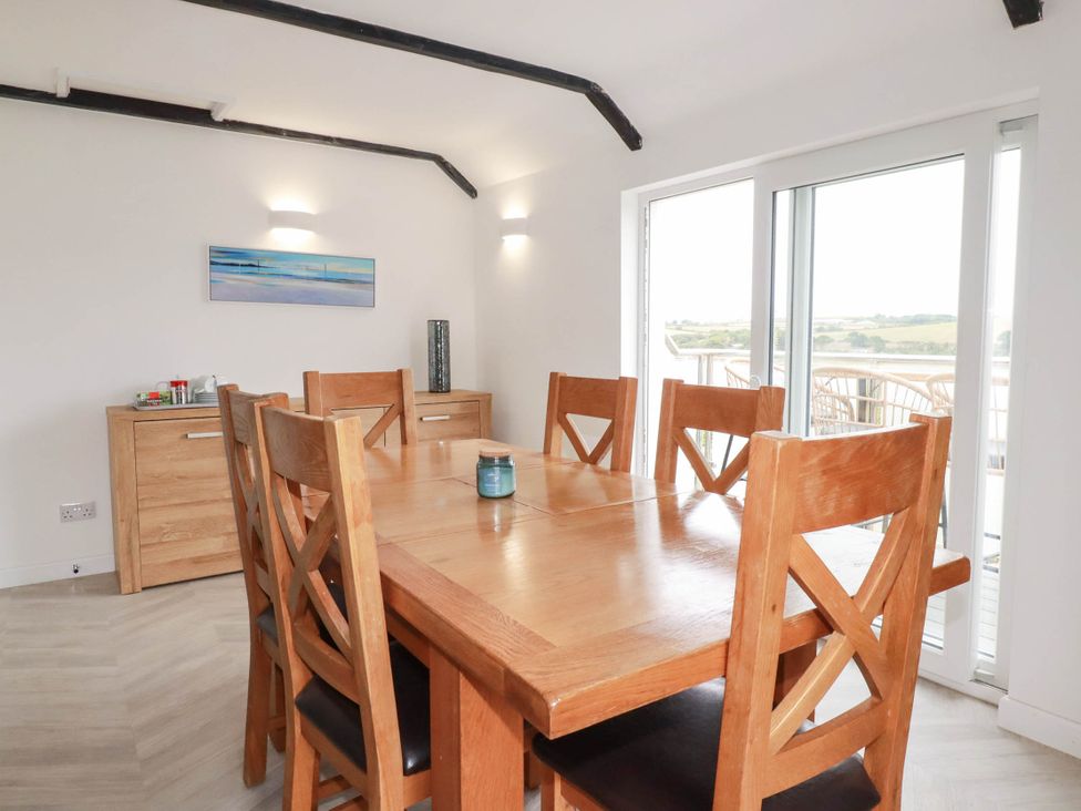 A dining room with a table and chairs at Little House in Wadebridge