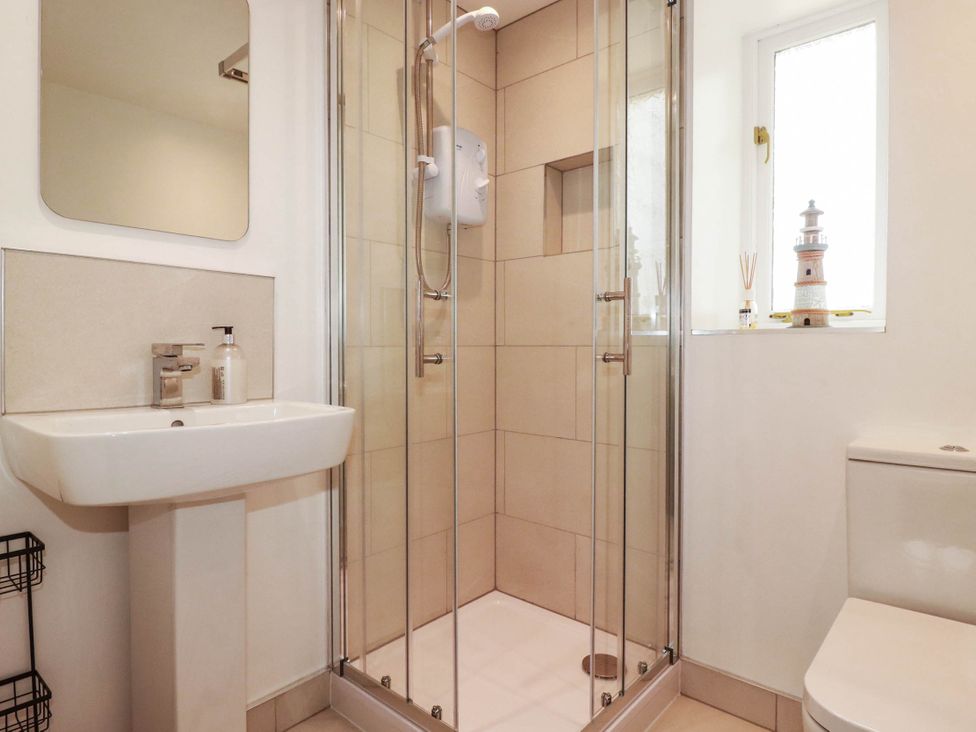 A bathroom with a shower and sink at Little House in Wadebridge
