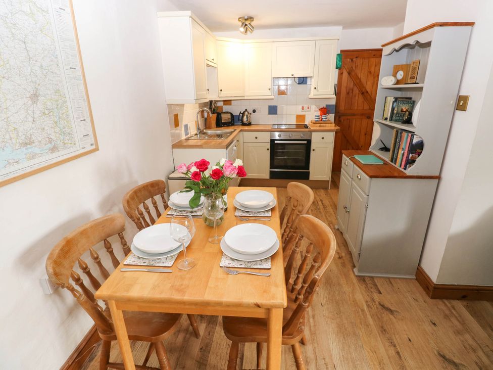 A kitchen with wooden table and chairs at The Old Dairy near Solva