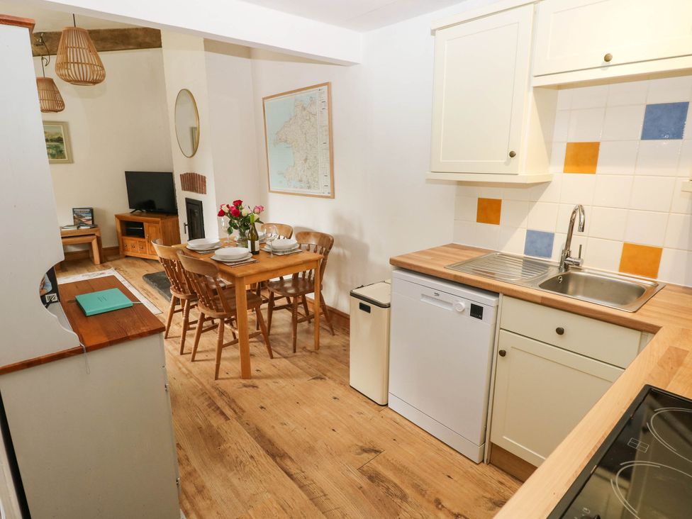 A kitchen with a dining table and chairs at The Old Dairy near Solva