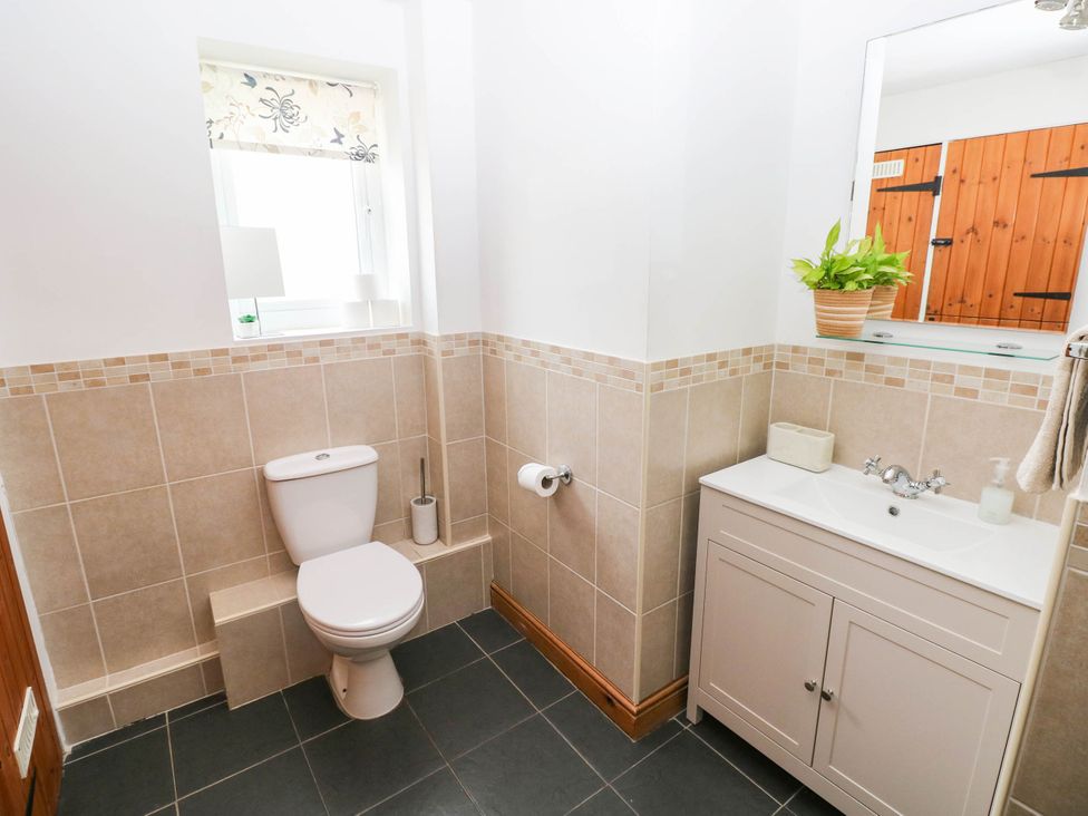 A bathroom with a toilet and washbasin at The Old Dairy near Solva