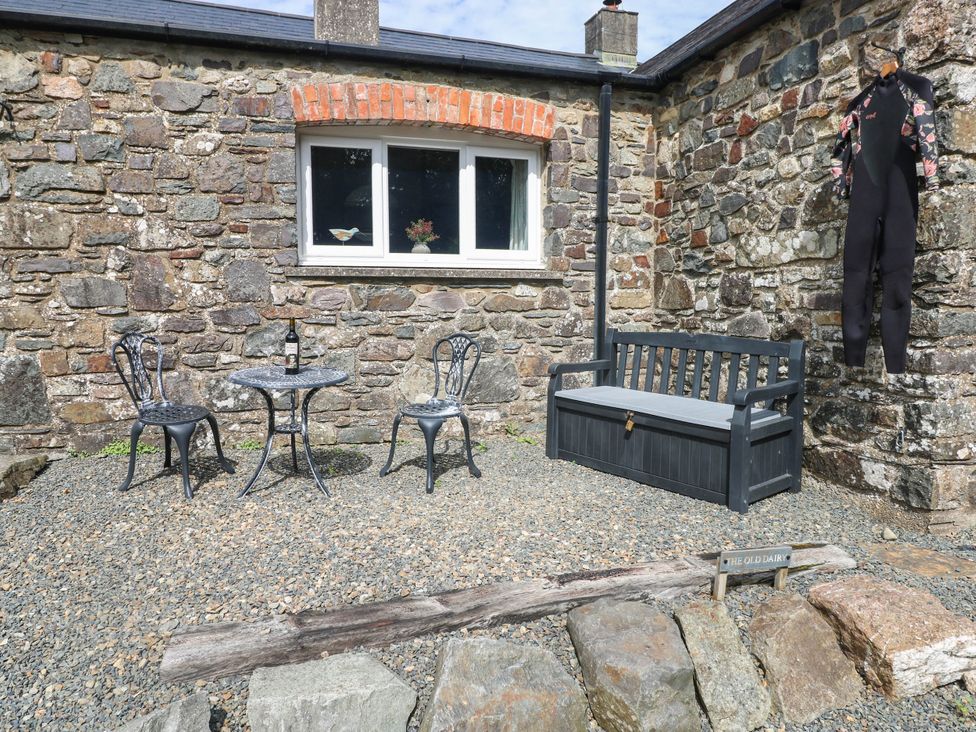 An outdoor area with a table and chairs at The Old Dairy near Solva