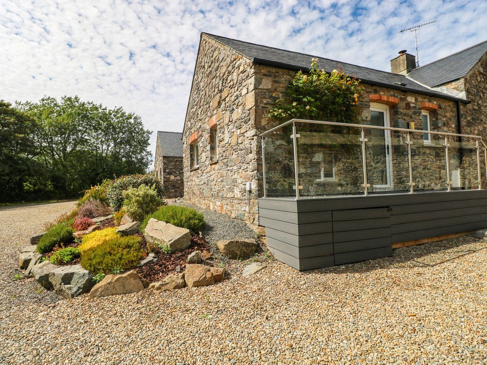 An outdoor area with a stone building and garden at The Old Dairy near Solva