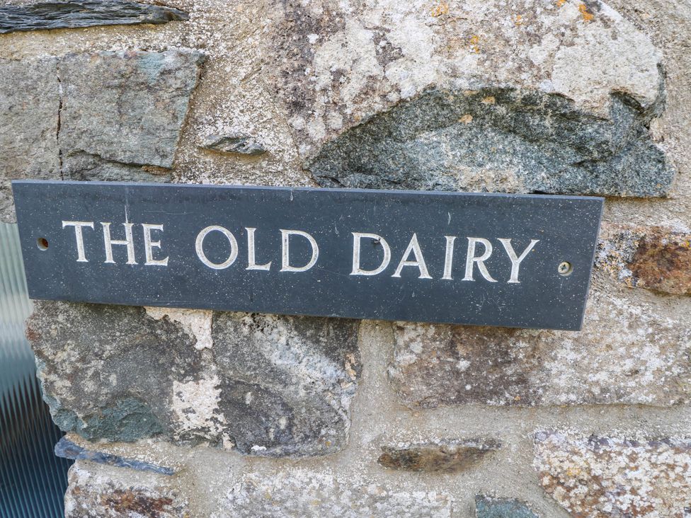 Sign on a stone wall at The Old Dairy near Solva