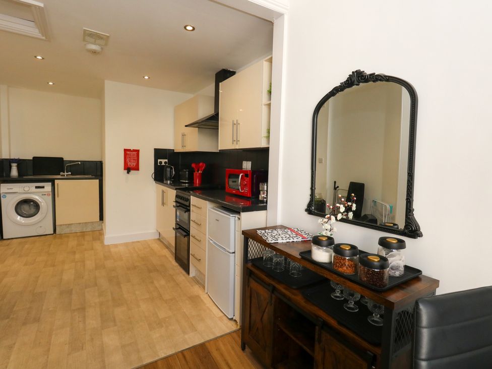 A kitchen with appliances and storage at Ocean Breeze in Weymouth