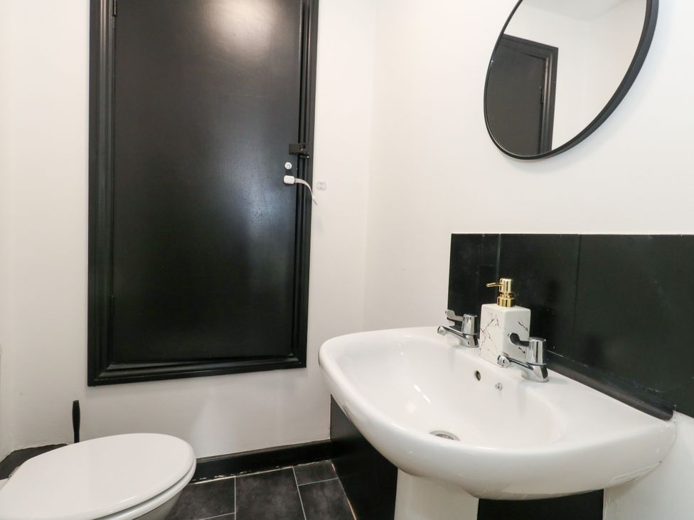 A bathroom with a toilet and wash basin at Ocean Breeze in Weymouth