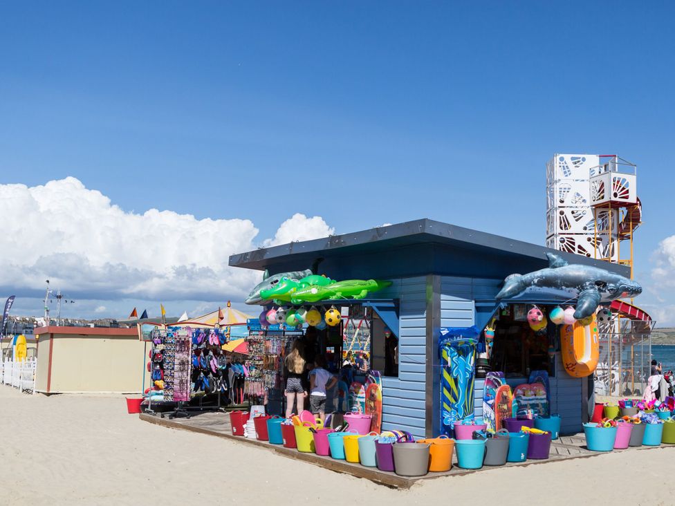 A beach kiosk selling swim gear and toys at Ocean Breeze in Weymouth