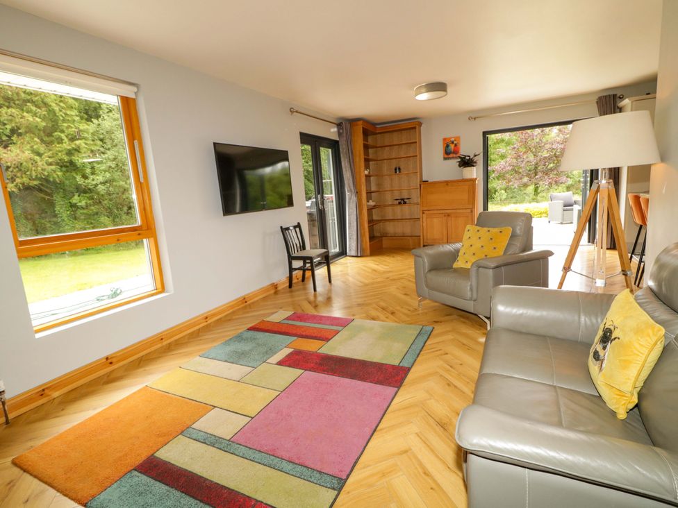 A living room with a sofa and tv at 3 bed property 