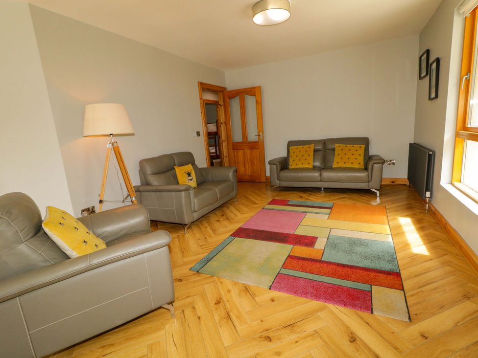 A living room with two sofas and a rug at 3 bed property