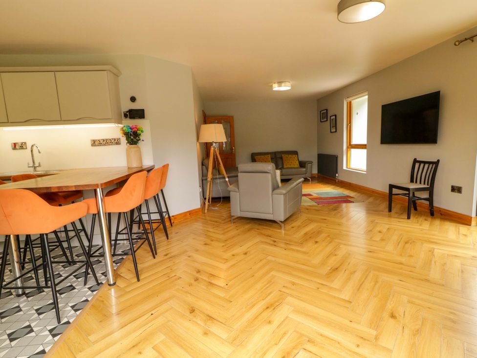 A living room with a dining table and chairs at 3 bed property