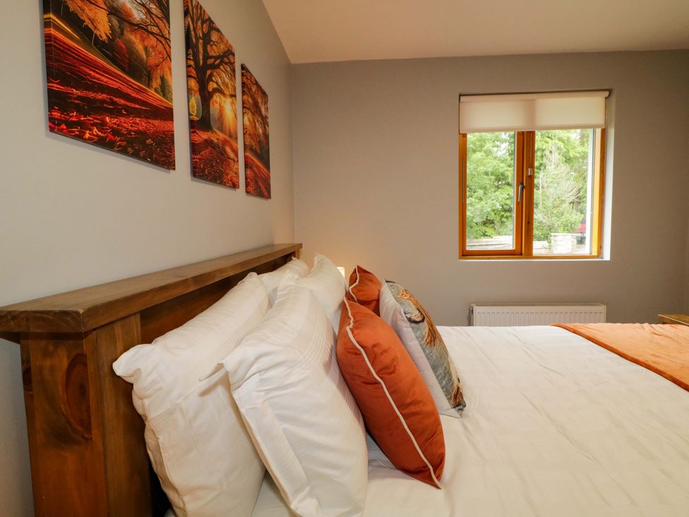 A bedroom with a bed and a window at 3 bed property