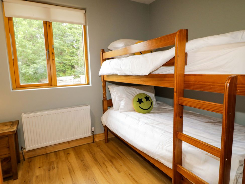 A bedroom with a bunk bed and a window at 3 bed property