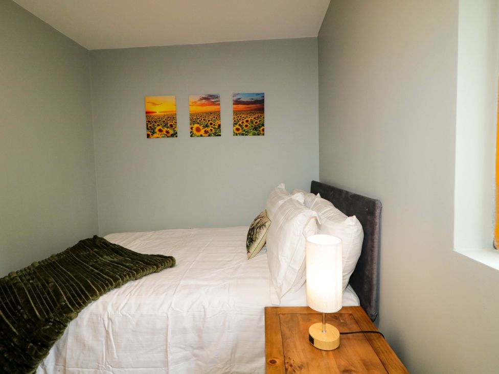 A bedroom with bed and artwork on the wall at 3 bed property 