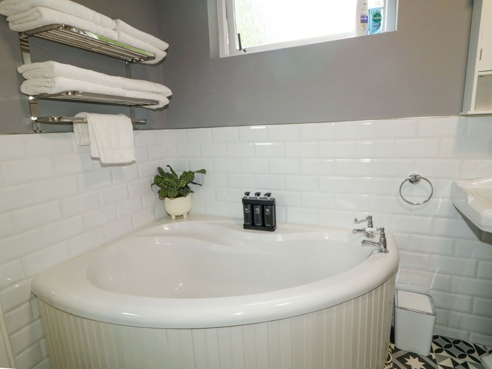 A bathroom with a bathtub and towels at a 3 bed property