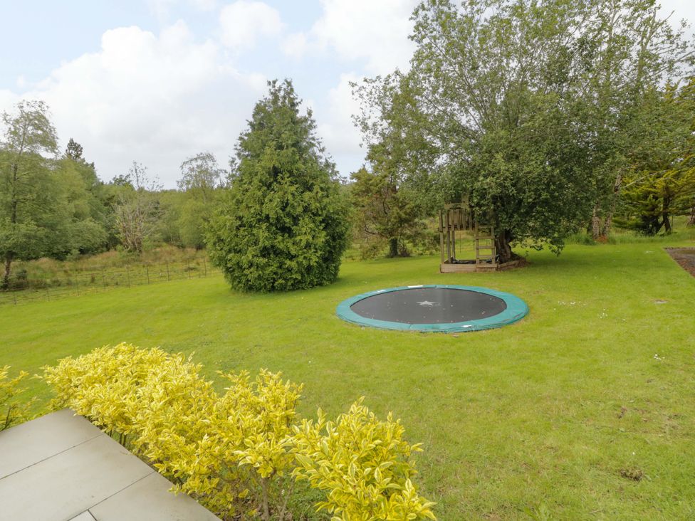 A garden with a trampoline and play structure at 3 bed property