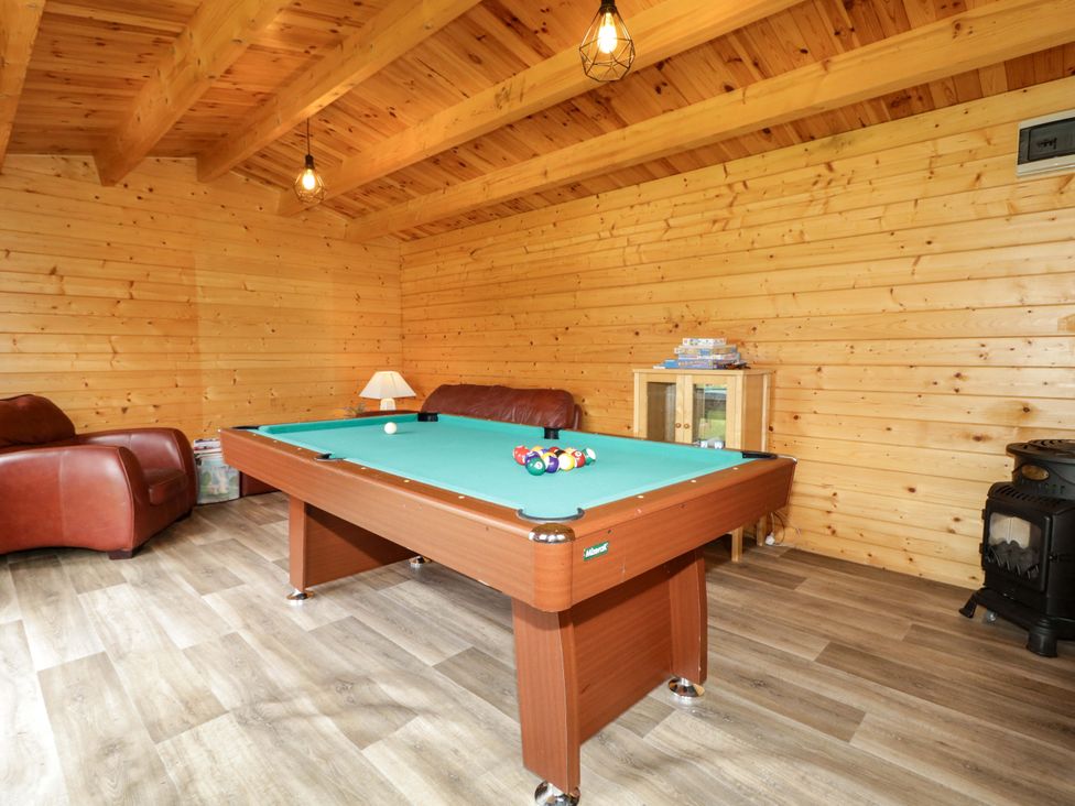 A snug featuring a pool table and sofa