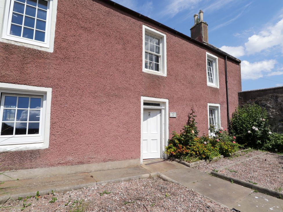 A house with windows and a door surrounded by a pathway and garden at 6 Hill Street