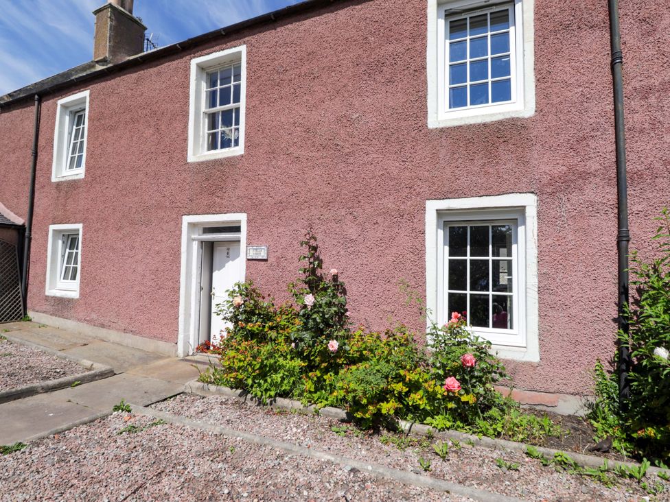 A house with a door and windows surrounded by flowers at 6 Hill Street