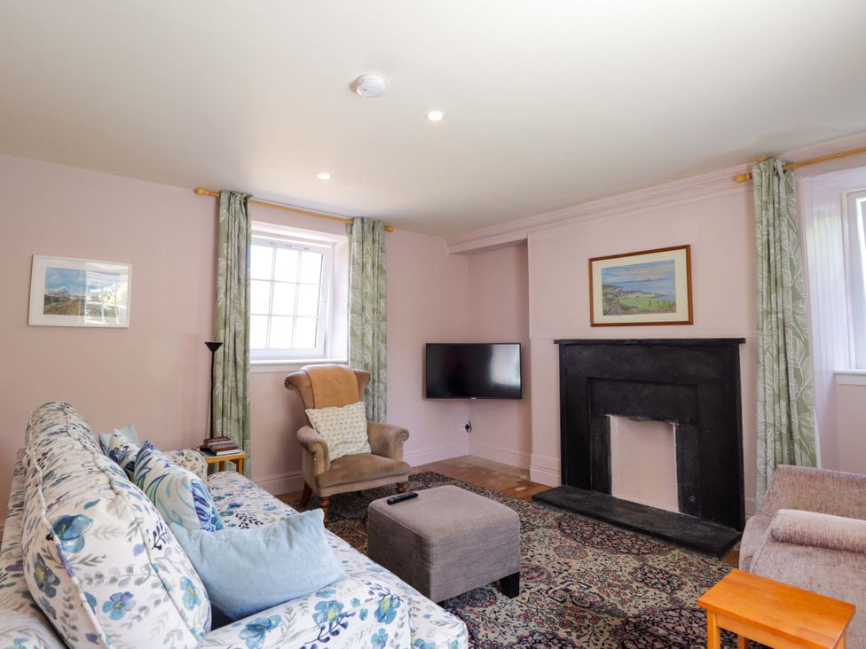 A living room with a sofa and television at 6 Hill Street
