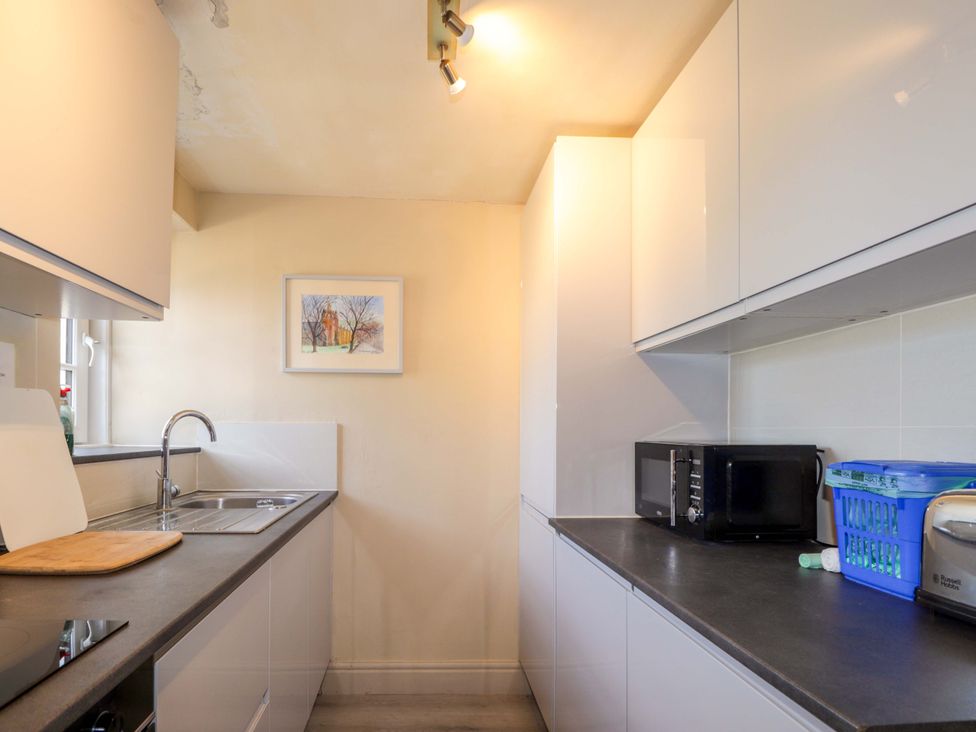 A kitchen with a sink and cabinets at 6 Hill Street