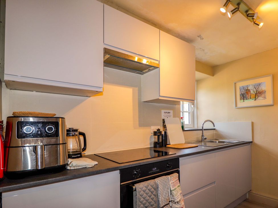 A kitchen with cabinets and appliances at 6 Hill Street 