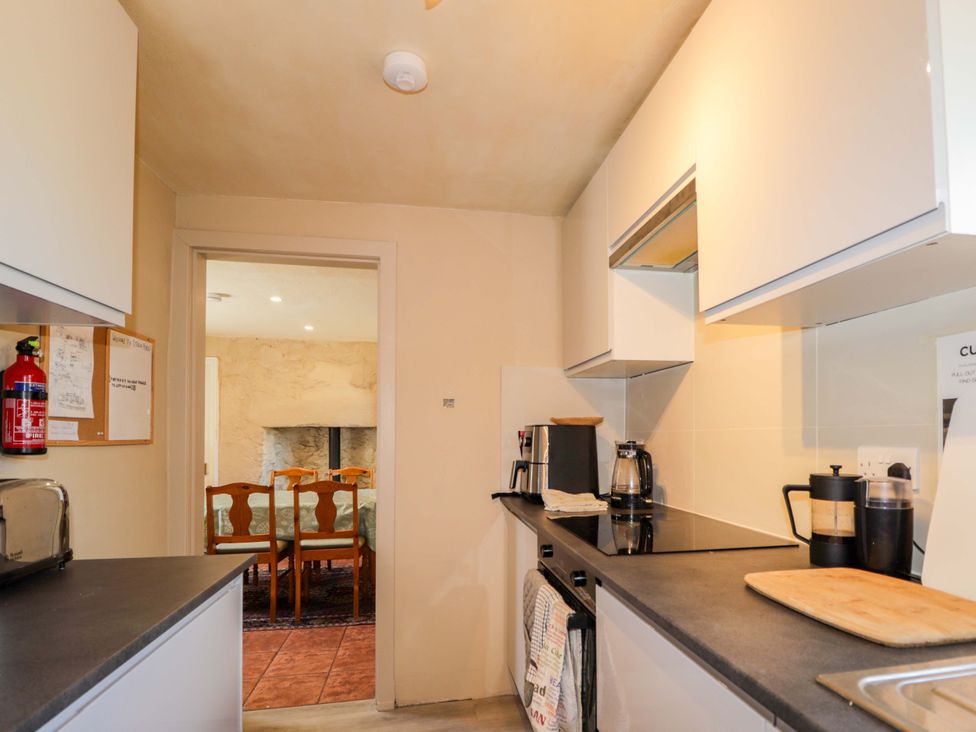 A kitchen with a fire extinguisher and coffee maker at 6 Hill Street 